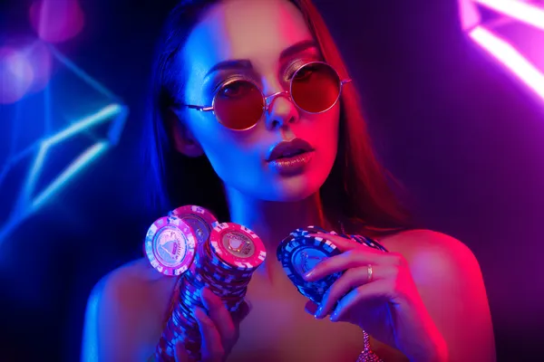A glamorous woman holding casino chips in a neon-lit environment, representing the premium online casino atmosphere of DBTJL.
